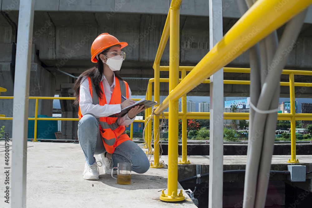 Environment Engineers controlling a quality of water ,aerated activated sludge tank at a waste water treatment plant. 