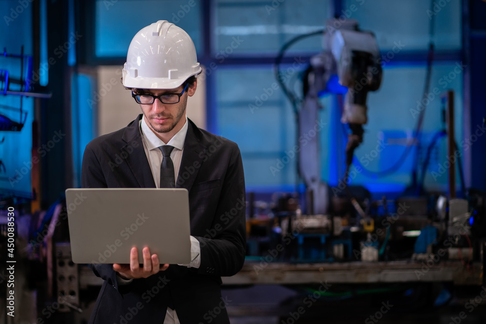 Engineer check and control automation robot arms.Robot arms machine in intelligent factory industrial on monitoring system software. Welding robotics and digital manufacturing operation. Engineer check and control automation robot arms.Robot arms machine in intelligent factory industrial on monitoring system software. Welding robotics and digital manufacturing operation.