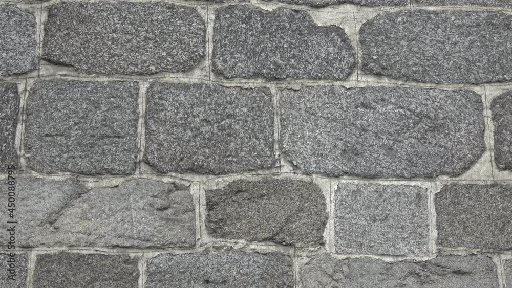 Detail of a stone wall with different size of rocks.