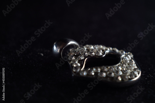 Closeup shot of a beautiful diamond brooch in the shape of a lip photo