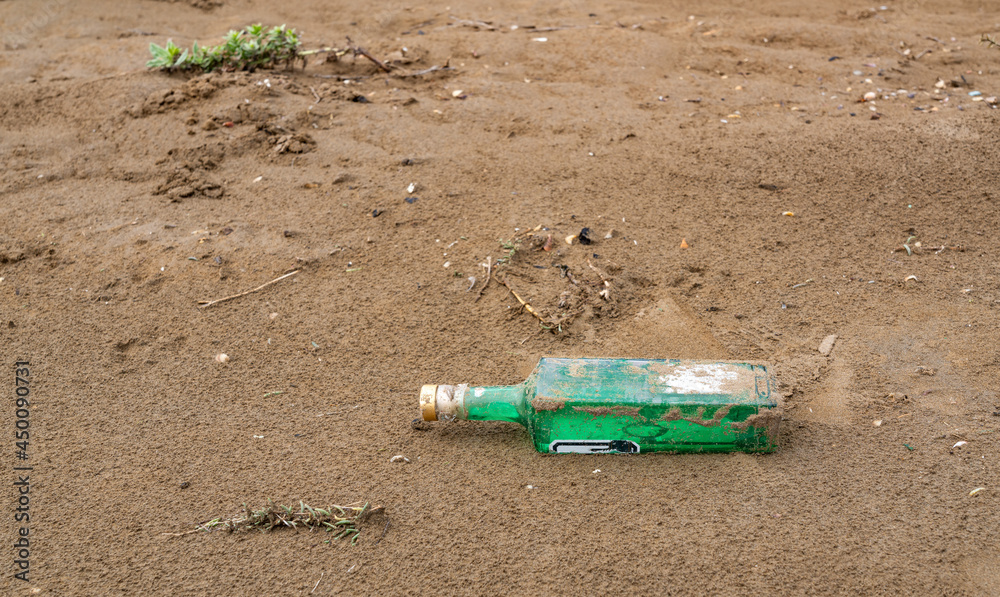 Abandoned glass bottle on the shore Abandoned glass bottle on the shore