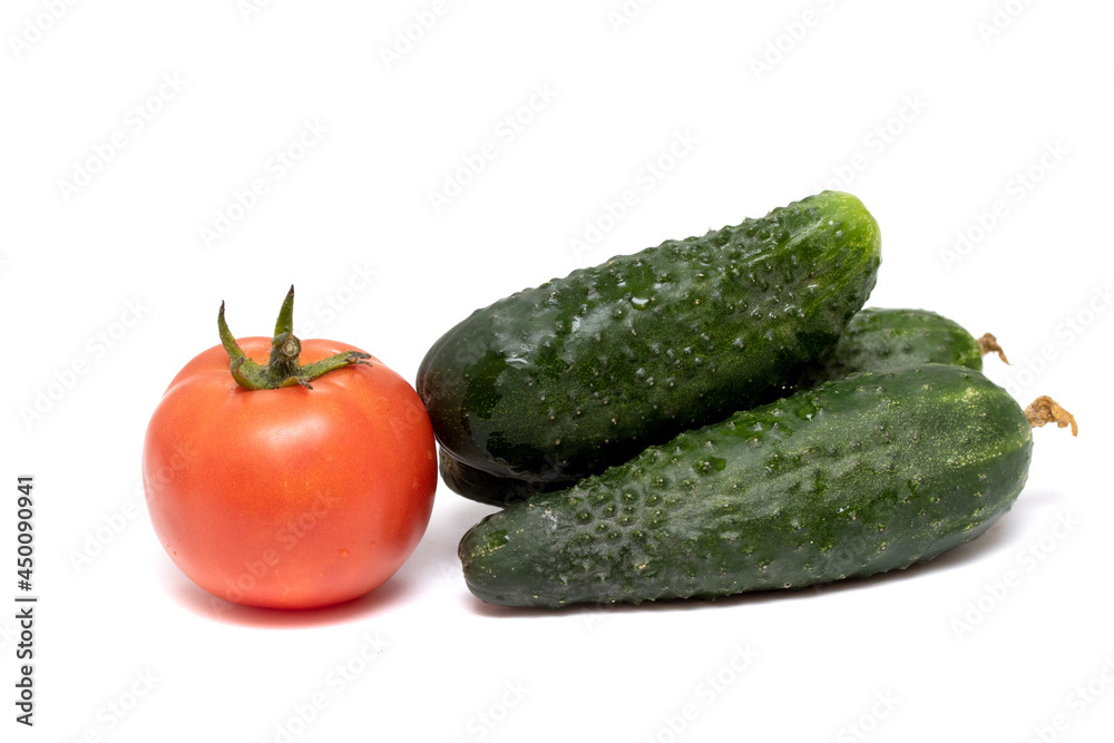 Red ripe tomato and green cucumber isolated on white background. Red ripe tomato and green cucumber isolated on white background.