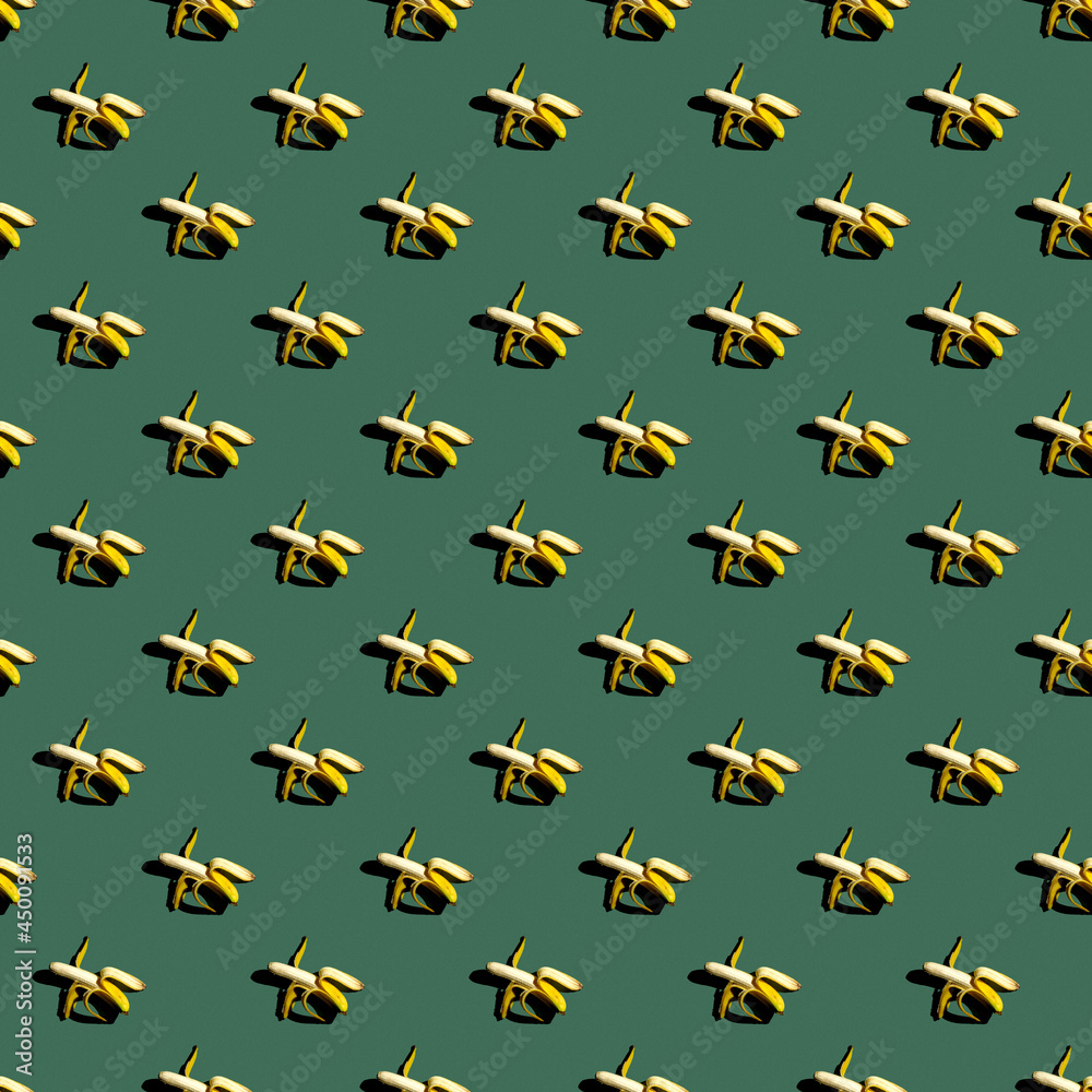 Seamless pattern of bananas on a uniform colored background.