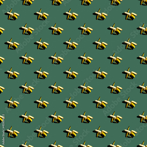 Seamless pattern of bananas on a uniform colored background.
