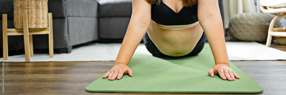 Overweight obese woman exercises on mat fitness Dieting and healthy lifestyle for burning fat.