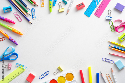 School supples frame on white background. Flat lay, top view colorful stationery. Back to school banner mockup.