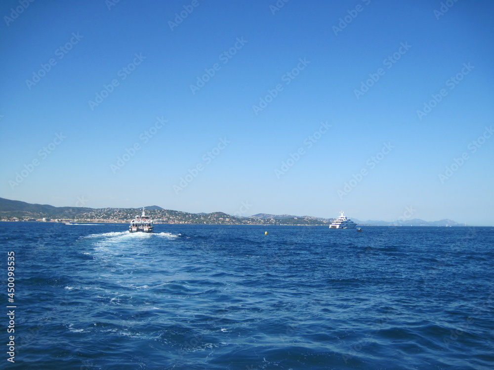 sailboat in the sea. Scenic shore line with view of the town on a sunny day