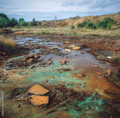 Chemicals leaching to the surface of derelict land from buried toxic waste, West Midlands.