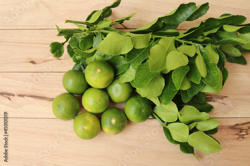 Lemons, Fresh Citrus hystrix fruits, vegetables, and herbs isolated on wooden background closeup.