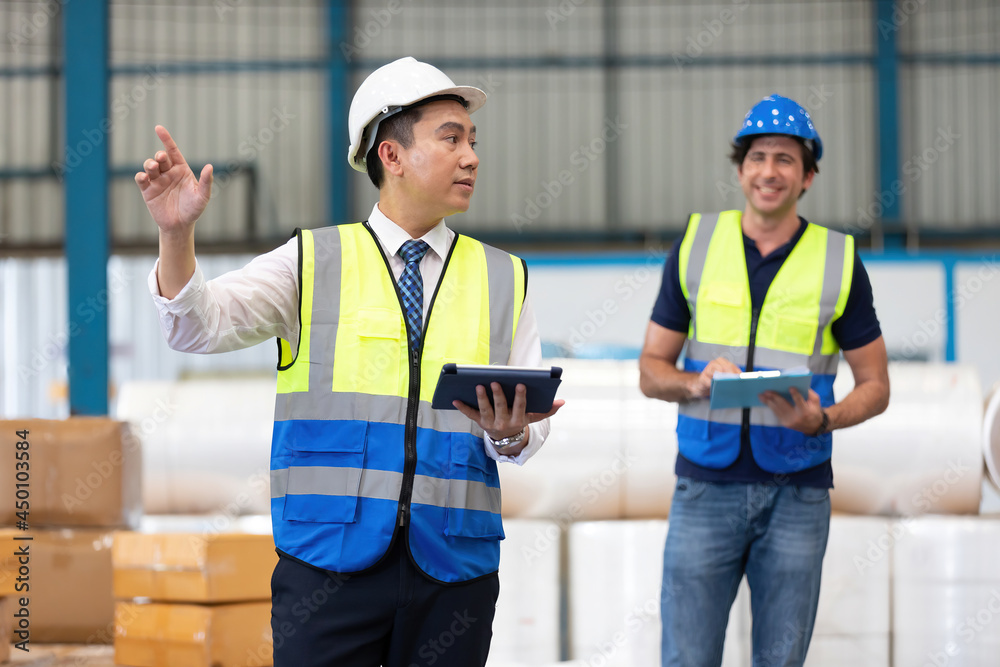 factory worker or engineer using tablet for preparing a job in warehouse storage factory worker or engineer using tablet for preparing a job in warehouse storage