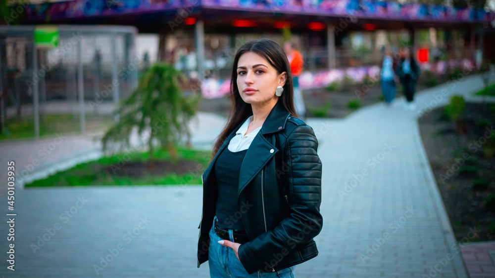 Fototapeta premium Portrait of a girl walking in the evening in the park