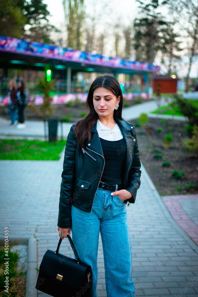 Portrait of a girl walking in the evening in the park