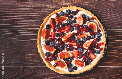 Fresh baked homemade fig and berries tart with mascarpone cheese