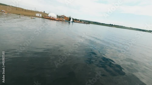 Wallpaper Mural Lake countryside. FPV flying drone over country river, with popular tourist beach, green coastline and peaceful water landscape. Summer recreation. Torontodigital.ca