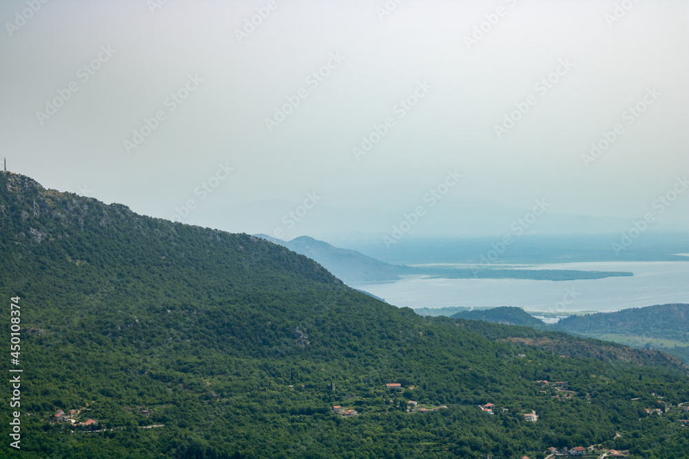 National Park lake Skadar and mountains Dinar highlands of the foggy morning. The largest lake on the Balkans, Montenegro. Popular tourist destination and beautiful nature landscape.