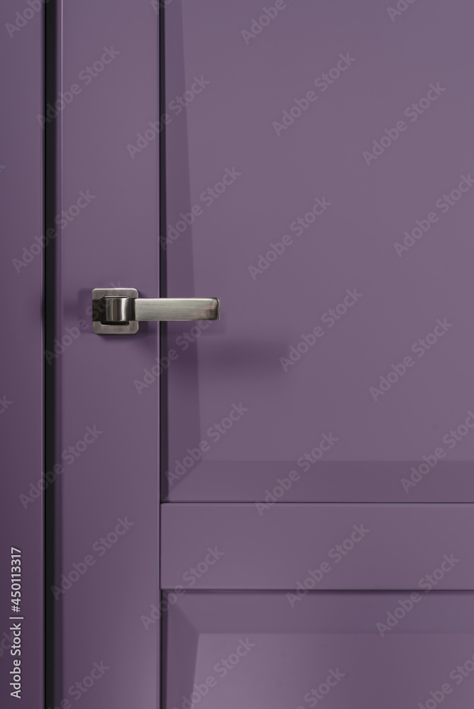 Stainless stylish door knob on violet wooden door Stainless stylish door knob on violet wooden door