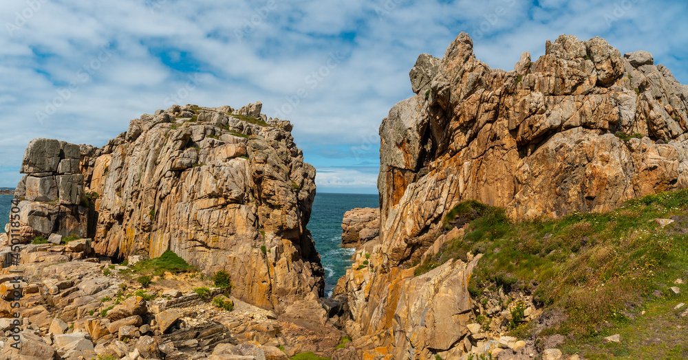 Panoramic view of the beautiful coastline at low tide of Le Gouffre de Plougrescant, Cote de Granit Rose, Cotes d'Armor, Brittany, France