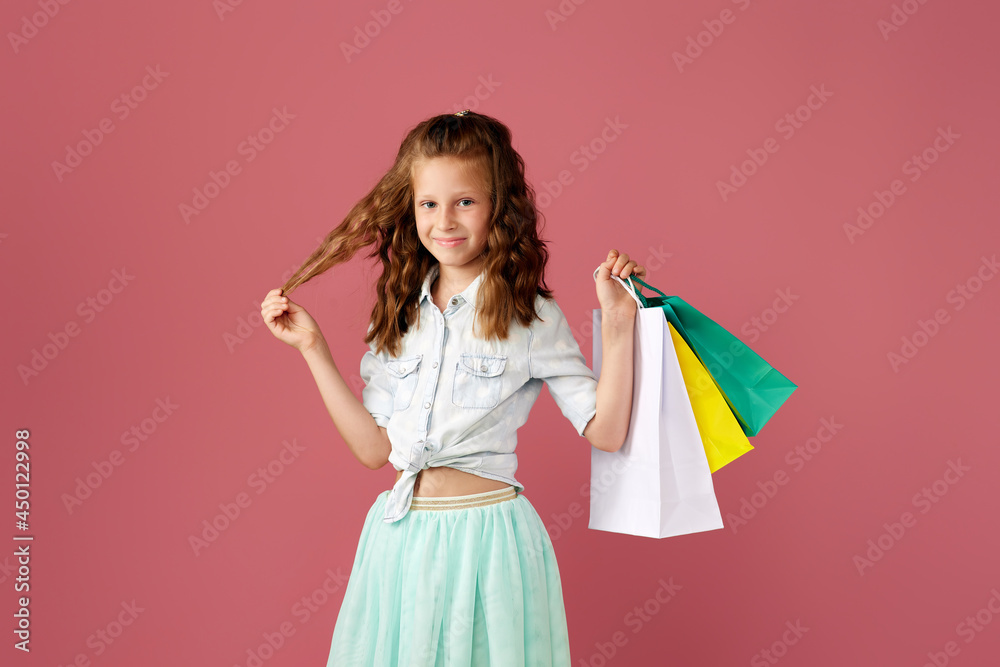 cute little caucasian child girl holds shopping bags cute little caucasian child girl holds shopping bags