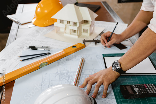 Civil Engineer calculate and sketch the drawing construction building. Engineer design work on blueprints on structural analyzing of project.