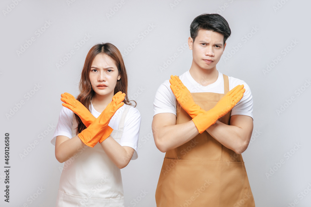 Portrait young couple in apron and glove pose thumbs up Portrait young couple in apron and glove pose thumbs up