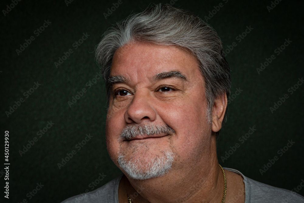 Obraz premium Man headshot closeup while he is with a little smile looking away