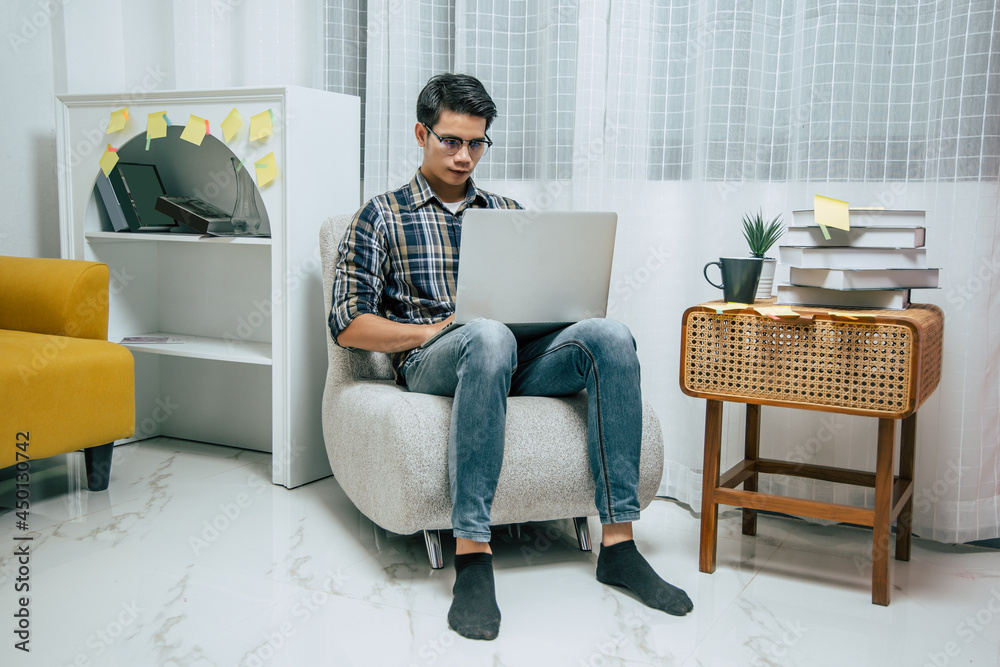 Young man working from home with laptop computer