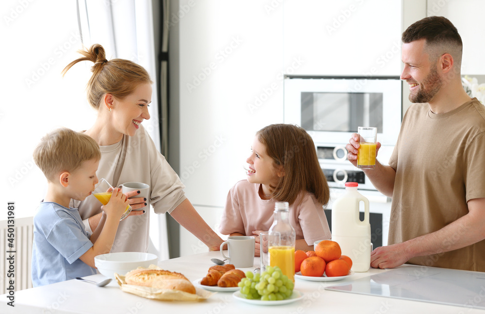 Young happy family eating morning breakfast together at home Young happy family eating morning breakfast together at home