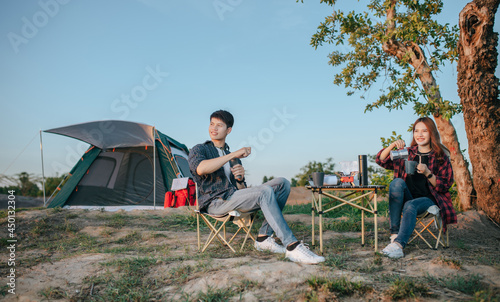 Young Couples enjoy camping with morning coffee.