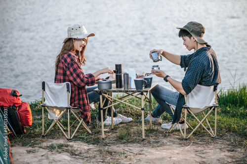 Cheerful Young Couples camping with morning coffee.