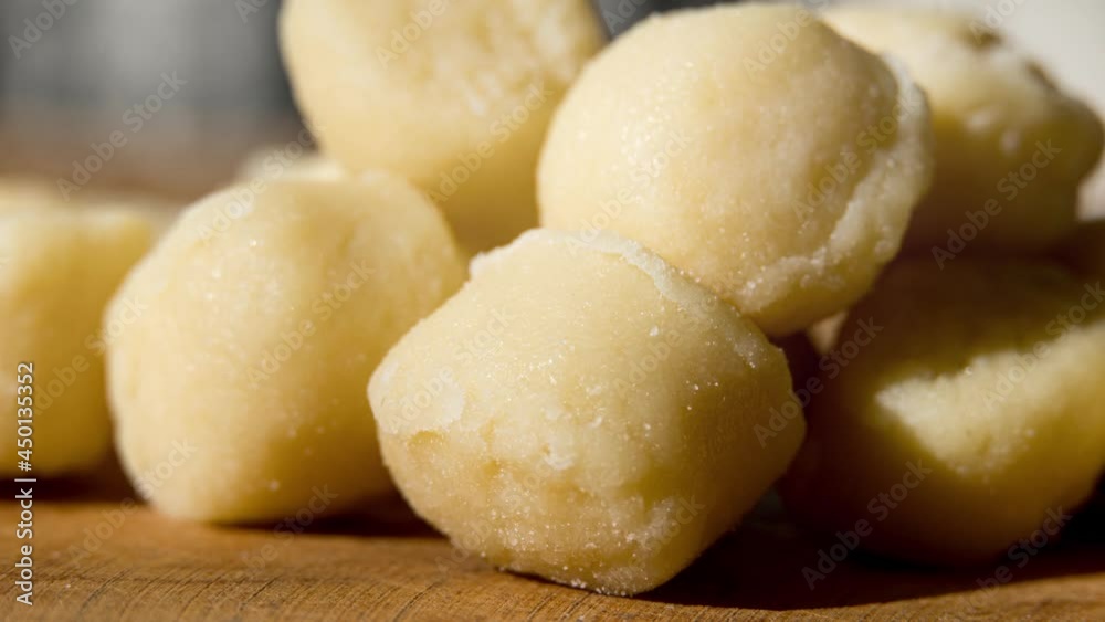 Pre-cooked gnocchi potato dough on wooden board. Macro close up. Selective focus. Pre-cooked gnocchi potato dough on wooden board. Macro close up. Selective focus.