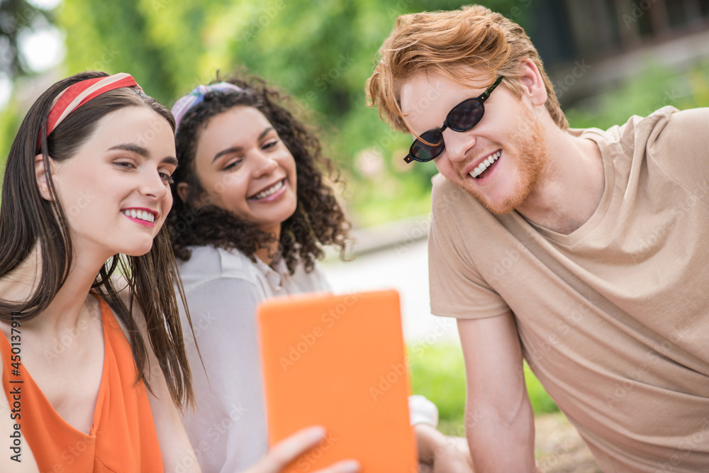 Three friends taking selfie on tablet Three friends taking selfie on tablet