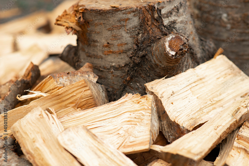 Stacks of firewood.Firewood background. A pile of stacked firewood, prepared for heating the house. Gathering fire wood for winter or bonfire. Stacks of firewood.Firewood background. A pile of stacked firewood, prepared for heating the house. Gathering fire wood for winter or bonfire.