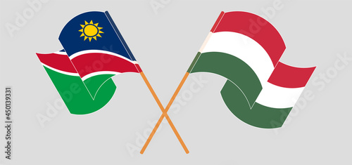 Crossed and waving flags of Namibia and Hungary