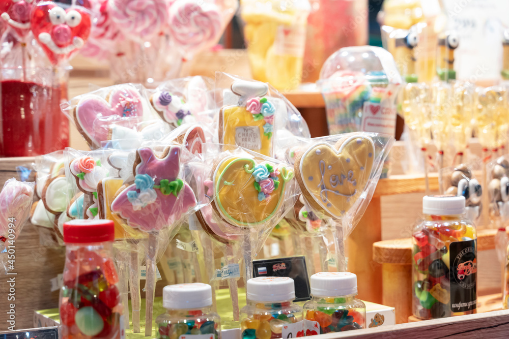 Cane candy, Many striped colorful traditional handmade christmas candies, lollipop, canes, sweets, treats at the counter of a store. Kids love white and red sweets.