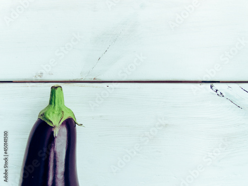 Fresh healthy eggplant on white wooden background. Additional space for text.