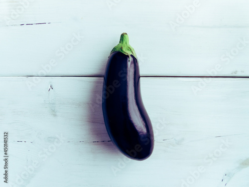 Fresh healthy eggplant on white wooden background. Additional space for text.