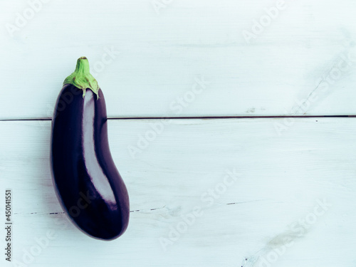 Fresh healthy eggplant on white wooden background. Additional space for text.