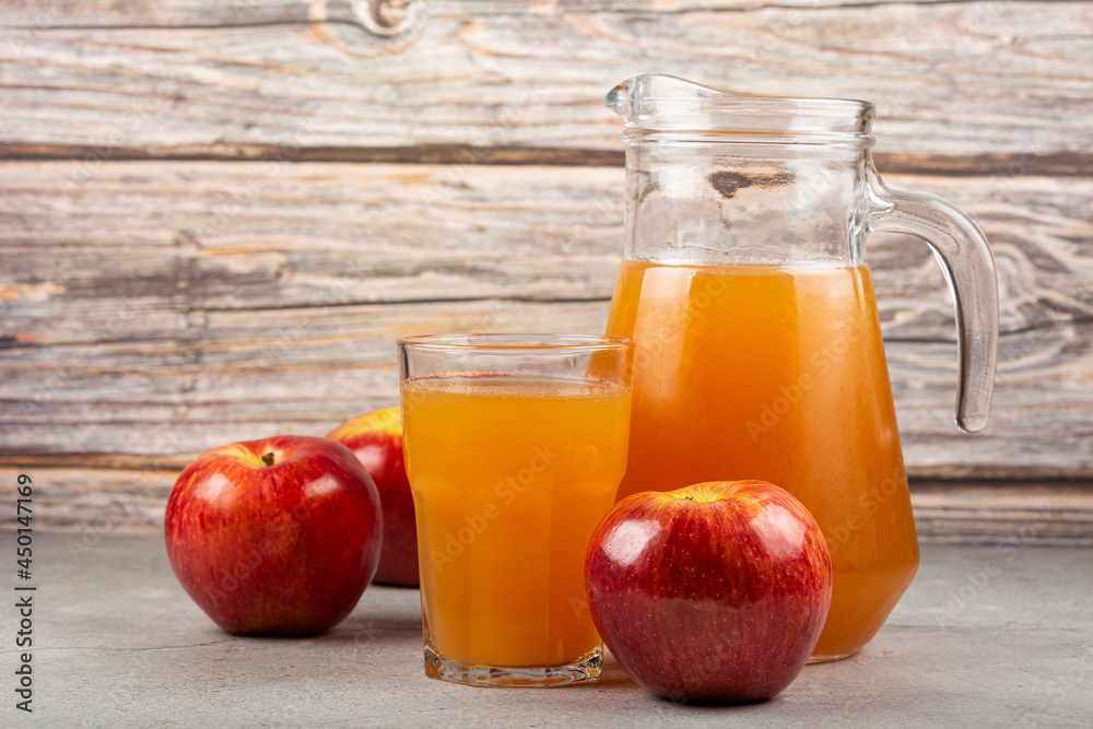 Apple juice and red apples on the table. Apple juice and red apples on the table.