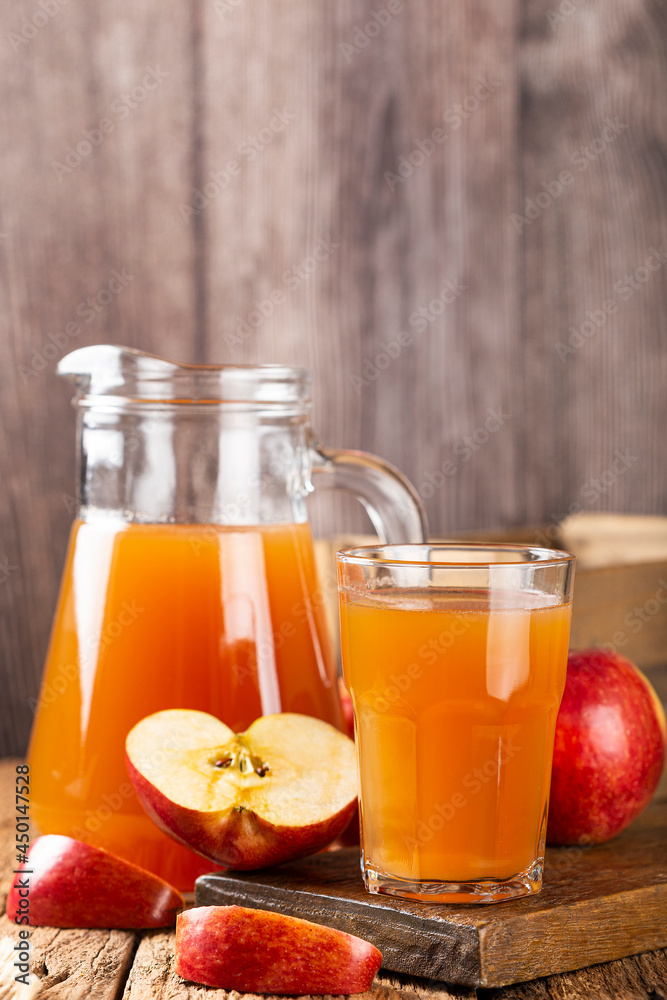 Apple juice and red apples on the table. Apple juice and red apples on the table.