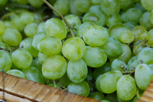 bunches of green grapes on the store counter close up