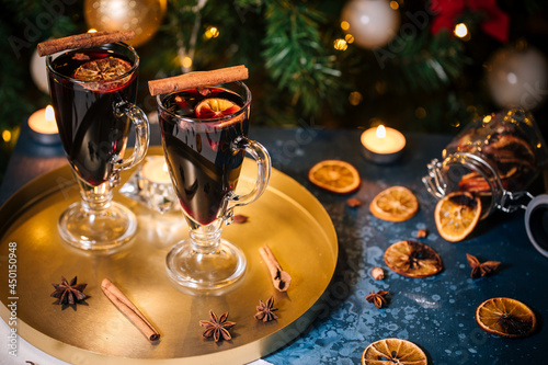 Mulled wine with cinnamon and orange served in festive Christmas decoration