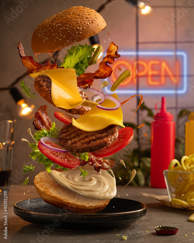 Tableau sur toile Burger with flying ingredients
