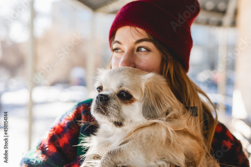Slika na platnu Girl walks with a dog Tibetan spaniel on a street