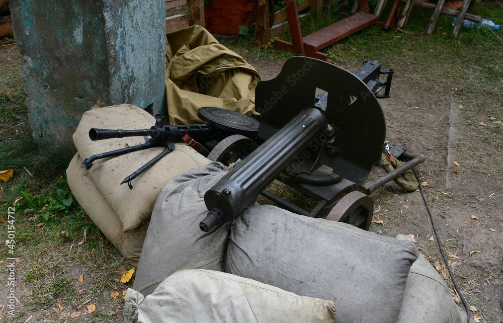 A close up on an old replica of a machine gun made out of metal located