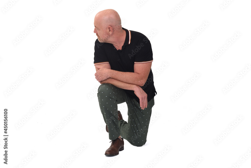 front view of a man looking away leaning on one knee on the ground on white background front view of a man looking away leaning on one knee on the ground on white background
