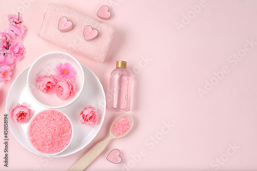 Spa and wellness composition with aromatic rose water, salt, roses, archidea flowers and sakura, aromatherapy and skin care, lifestyle concept, invitation and advertising,