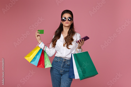 woman holding bag, credit bank card and mobile phone