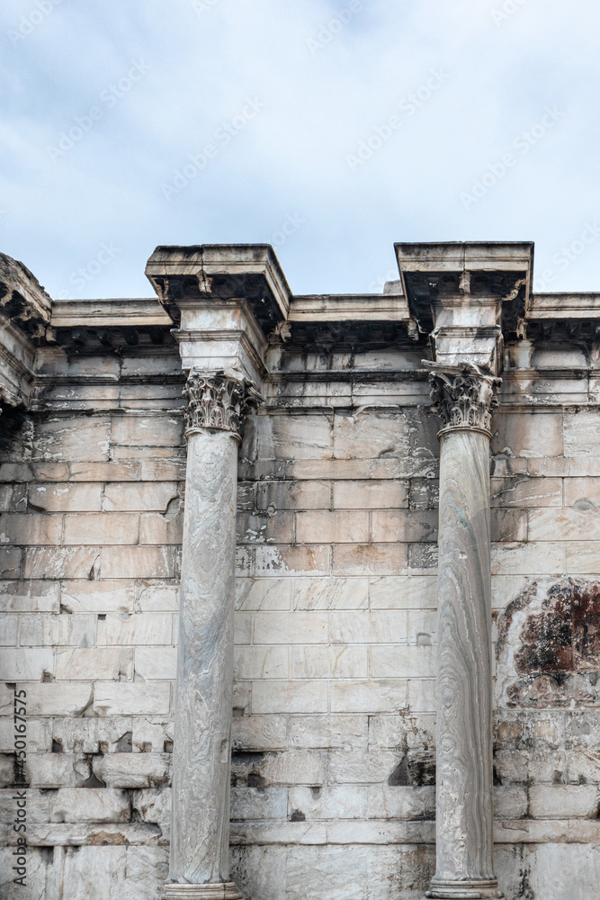 Hadrian's Library wall green marble Corinthian columns close-up. Ancient Greek colonnade architecture details in Athens, Greece. Vertical view