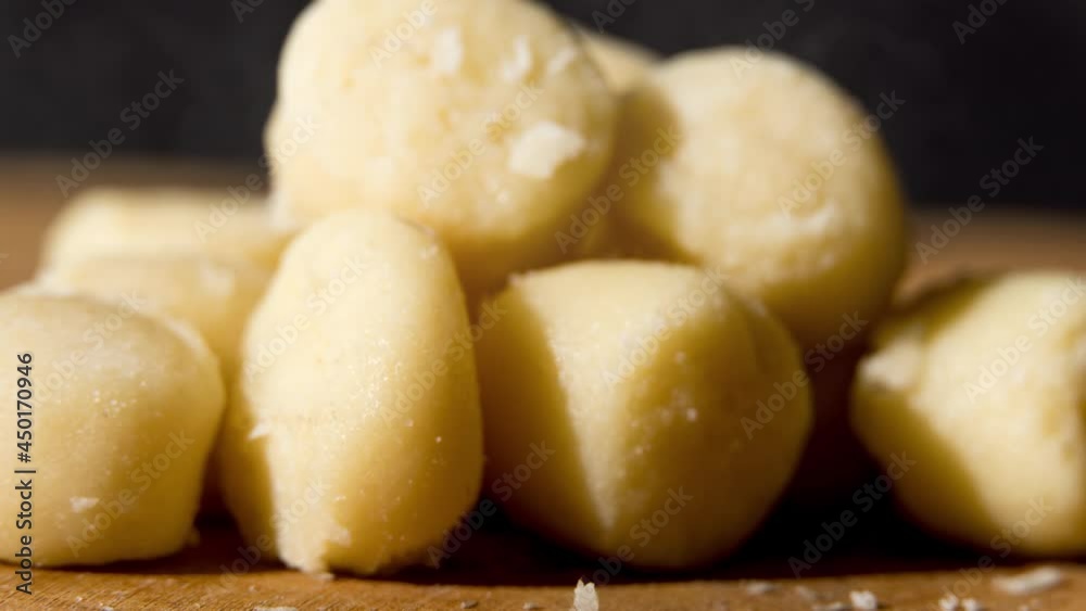 Pre-cooked gnocchi potato dough on wooden board. Macro close up. Selective focus. Pre-cooked gnocchi potato dough on wooden board. Macro close up. Selective focus.