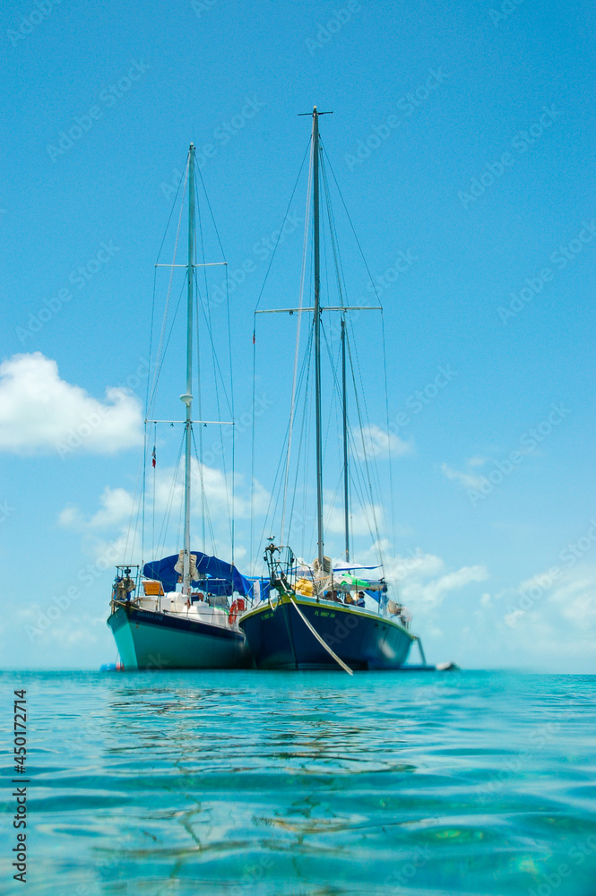 Twin Sailing Yachts Anchored in the Bay